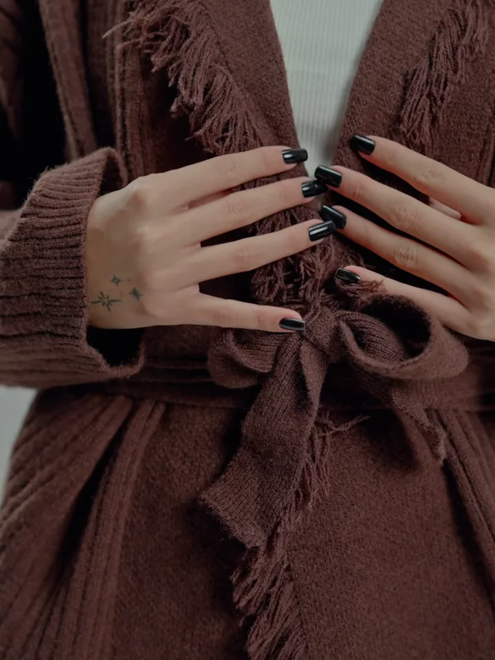 A close-up of EXIT's textured fringe knitwear from the FW26 campaign